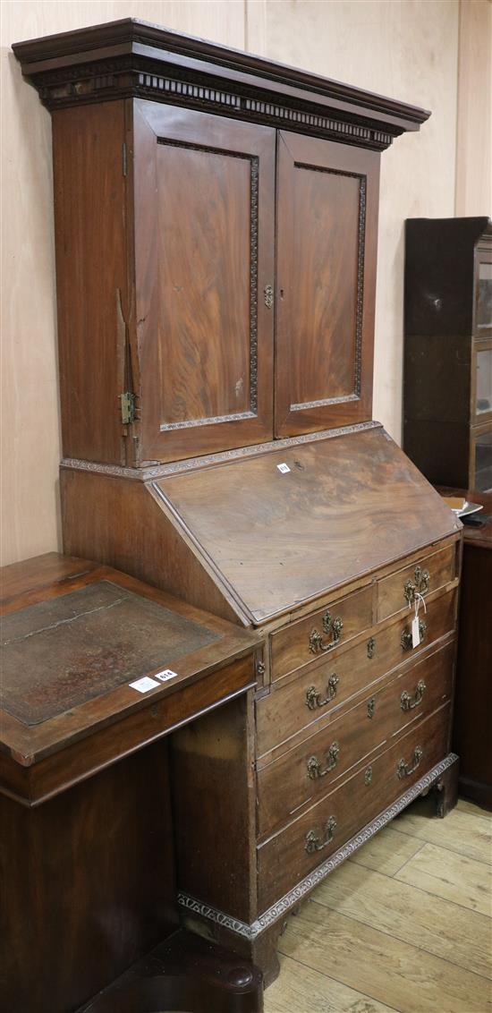 A George III mahogany bureau, with later bookcase top, W. 106cm